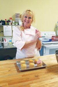 Bo Mashburn-Hager frosts cupcakes in her kitchen at StaarrCakes Bakery. Photo by Bethany Turner