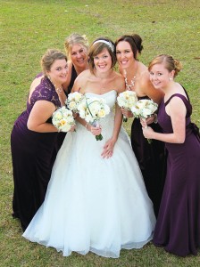 Ashley and her bridesmaids, dressed in elegant eggplant gowns. 