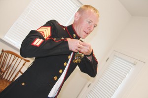 Sergeant Gettler donning his Marine Corps Dress Blue uniform. 