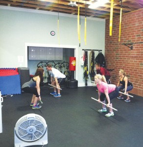 Samantha Stephens leads a CrossFit class at her gym, Cape Fear Fitness. Photo by Kris Beasley