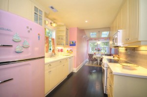 The kitchen oozes retro appeal, complete with a pink fridge. Photo courtesy of Yost and Yost, Intracoastal Realty, Inc. 