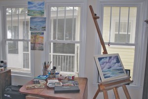 Mary Louise's whimsical landscape paintings are on display in her studio, an addition the couple crafted. Photo by Bethany Turner