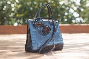 Chanel replica sunglasses, $16; Tanner Croc Bag by Doncaster, $95; all from The Prissy Parrot Consignment Boutique (503 N. Howe St., 910-523-1203).