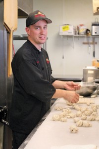 Pizza chef Joel Wilcox is a New York transplant. He crafts pizza in the NY style, and he ties garlic knots with quick fingers. 