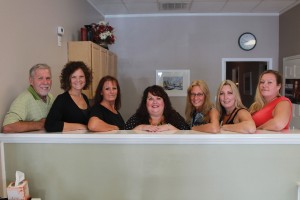 The staff of E Salon and Spa, from left to right: Joe Emery, Jenny Klein, Lynette Tatum, Shari Hylton, Yvonne Furrows, Kelli Rhyne, and Michelle Flores. Right: Ergonomic chairs and shampoo sinks relieve stress on the neck. Photos by Kris Beasley
