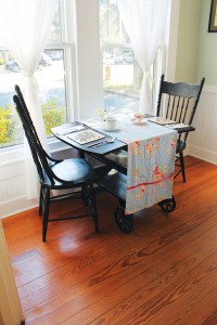 This antique tea cart, turned into a table for two, is where Linda Pukenas' love story with the Southport Tea House began. Photo by Bethany Turner