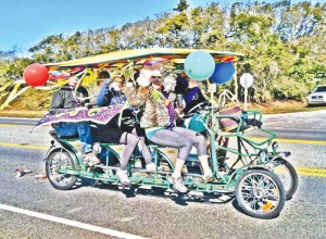 Missy Ronquillo (front), owner of Pescado Y Amor, and friends participate in last year's Oak Island Mardi Gras by the Sea Festival parade. Courtesy photo