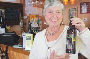 Candace Hobbs, showcasing the Jade IPA by Foothills Brewing Company, is the owner of The Grape & Ale (8521 E. Oak Island Dr., Oak Island) and a contributor to Southport Magazine. Photo by Kris Beasley