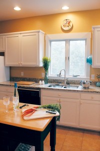 The kitchen features an island and brand-new granite countertops. Photo by Bethany Turner