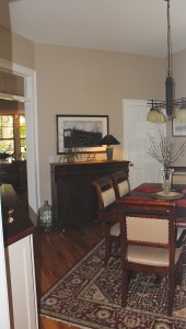 The dining room, complete with a passthrough to the kitchen, is painted in BM Bleeker Beige. Photo by Bethany Turner