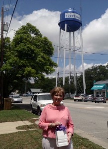 Barbara Gray, winner of $180 of gift certificates in front of the water tower. Courtesy photo