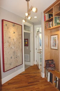 The zig-zag 'gallery' hallway, painted in BM Nimbus, while the built-ins are a light maple stained with clear satin lacquer by Finish Shop. Photo by Bethany Turner