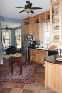 The kitchen offers custom hickory cabinetry with some open shelving, wood countertops, Marazzi tile in Walnut Canyon, and BM paint in Van Courtland Blue. Photo by Bethany Turner 