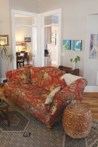 The living room features red oak flooring and Benjamin Moore (BM) paints in Nimbus for the walls and Cotton Balls for the trim. Photo by Bethany Turner