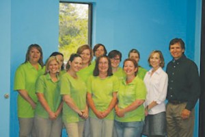 Donna and Chuck Parker—Merry Maids franchisees covering Brunswick, New Hanover and Pender counties—with their staff. Photo courtesy of the Parkers