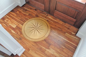 Inlaid wood presents a compass set to point exactly north in the foyer. Photo by Bethany Turner