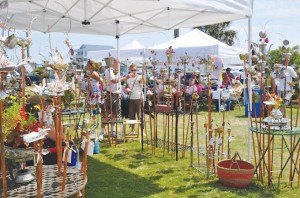 Guests of a past Oak Island Art Guild Arts and Crafts Festival peruse metal works crafted for lawn and garden use. Courtesy photo