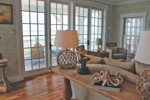 Hand-scraped African teak sets an earthy tone for the Carbonell home. Artwork from their global travels, such as sculptures and paintings, appear throughout. The octopus was created by ceramic artist Shayne Greco of Wilmington, NC. Photo by Bethany Turner