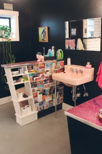 Black walls allow the pink bathroom fixtures to pop; Meehan found the fixtures in Raleigh, NC. Photo by Bethany Turner