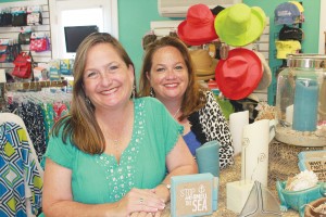 Paige Brown (left) and Melaney Robbins pose inside Color Me Carolina, an Oak Island shop for cute décor and more. Photo by Kris Beasley