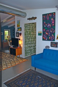 Sitting area and "homemade wallpaper," or a loop-de-loop paint design Meehan crafted in green for her hallway. Photo by Bethany Turner