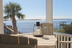 The screened porch off the main living area offers a view off the Atlantic Ocean, Cape Fear River, and Intracoastal Waterway as they collide in front of Southport. Photo by Bethany Turner