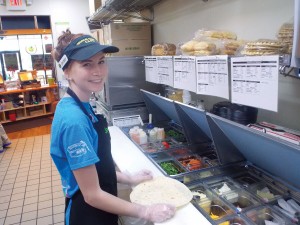 Employee Jordan Anderson prepares a flatbread sandwich at Tropical Smoothie Café. Photos by Rebecca Jones