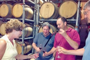 Southport residents Nancy Neidig, Joaquin Carbonell and Bob Neidig join Winemaker Carl Wicka (red shirt) of Turley Wine Cellars in a barrel tasting. Photo by Amanda Carbonell